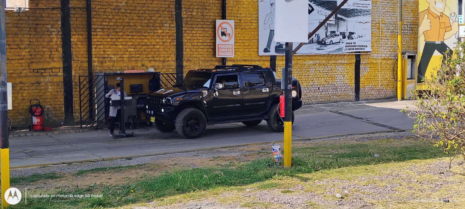 Image of a vehicle undergoing technical inspection in a modern facility